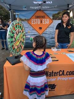 Photo of young girl participating at Patrias booth